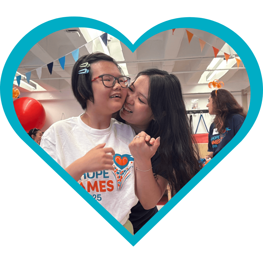 iHOPE student and staff member embrace each other.