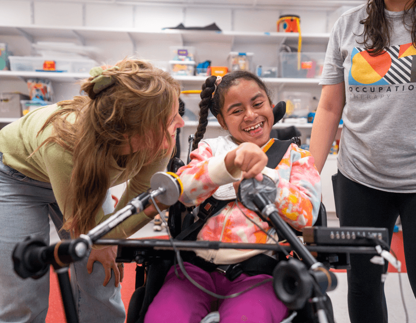 iHOPE student smiling and interacting with staff. 